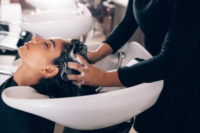 Woman getting hair shampooed at salon Viviscal Blog